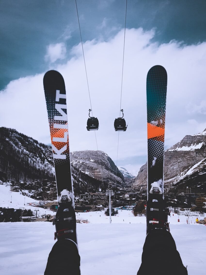 person sitting on snow wearing snow skis